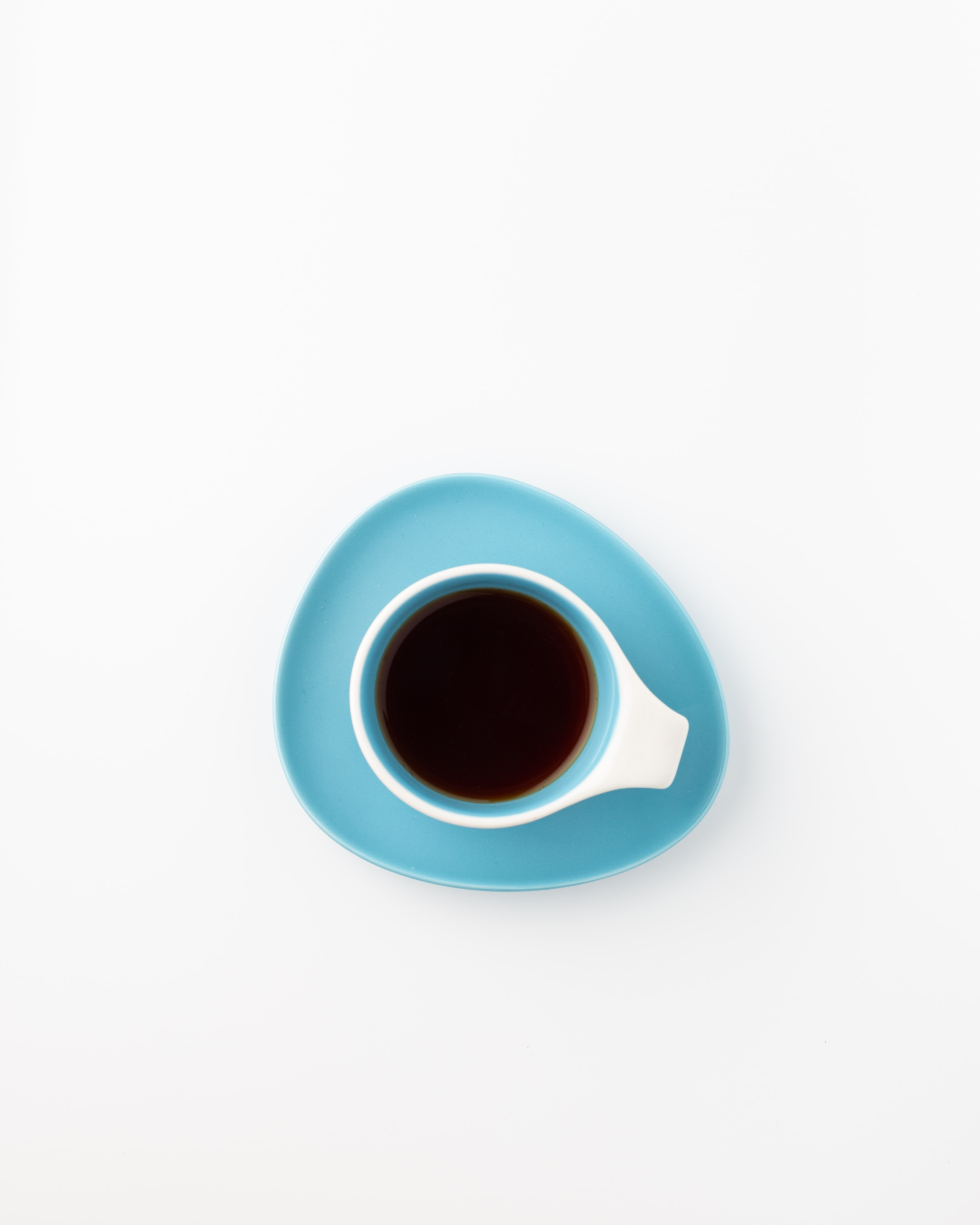 青いカップに注がれたブラックコーヒー